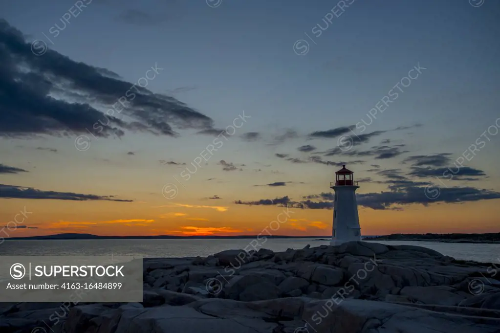 Lighthouse at Peggy's Cove near Halifax, Nova Scotia, Canada in sunset.