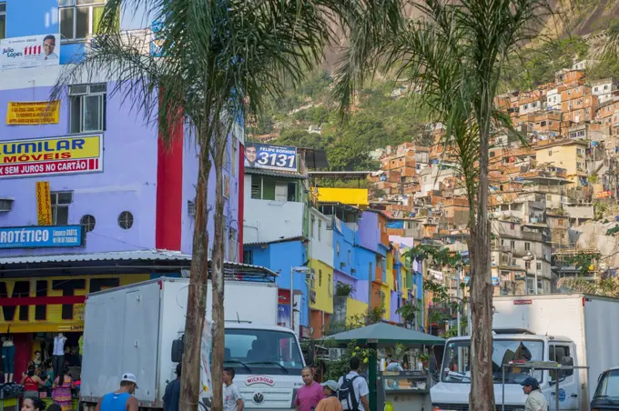 Street scene with colorful painted houses in the Rocinha favela, the largest favela in Brazil, in Rio de Janeiro, Brazil.