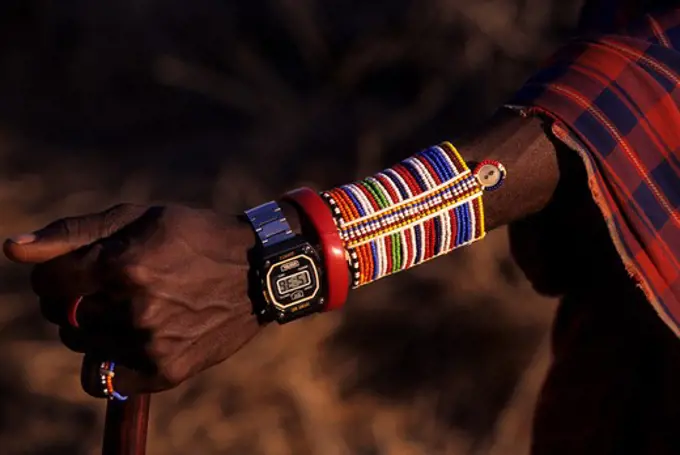 KENYA, AMBOSELI, MASAI MAN, CLOSE-UP OF ARM JEWELERY WITH MODERN WATCH