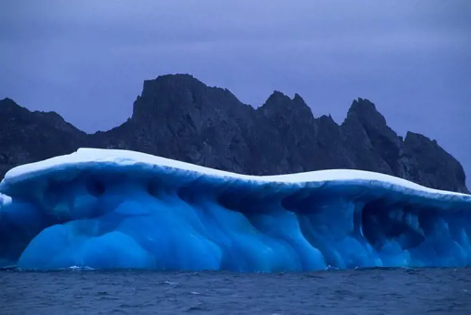 ANTARCTICA, NEAR ELEPHANT ISLAND, MARBLED BLUE ICEBERG..