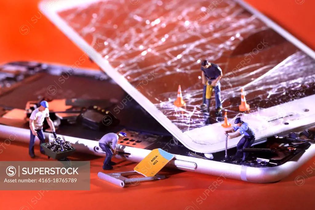 Miniature People Fixing and Repairing a Cracked Broken iPhone 