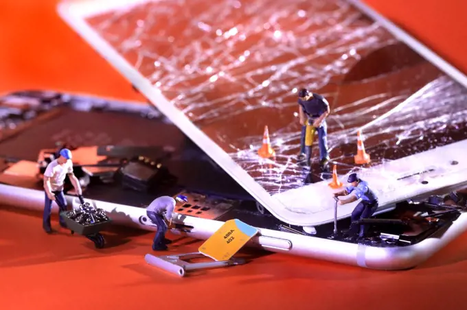 Miniature People Fixing and Repairing a Cracked Broken iPhone 