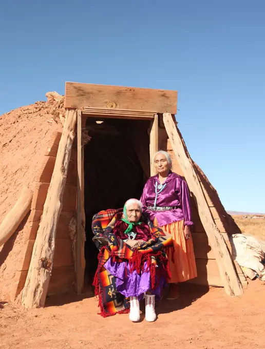 Mother and Daughter Traditional Navajo Women Posing Outside a Traditional Hogan