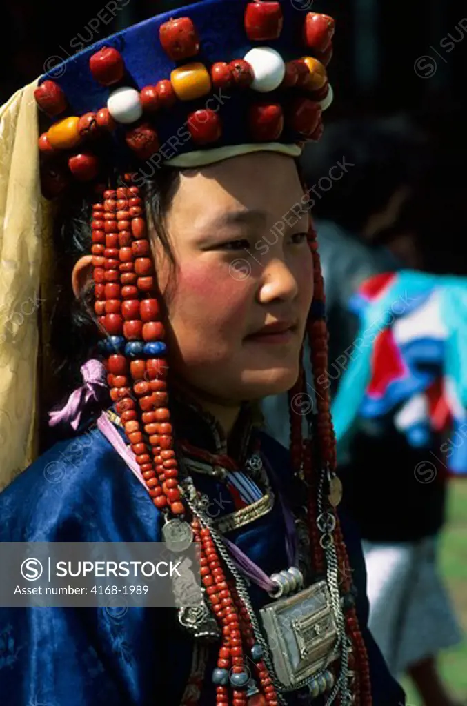 RUSSIA, SIBERIA, NEAR ULAN UDE, PORTRAIT OF YOUNG WOMAN IN TRADITIONAL BURYAT DRESS