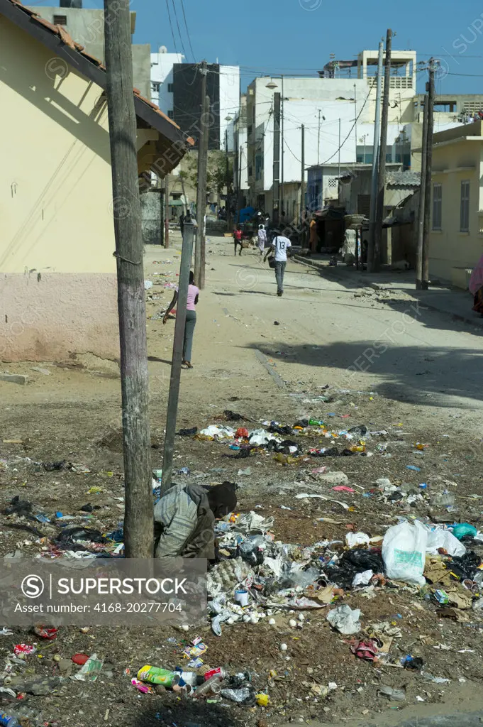 Poor man sifting through garbage for food in Dakar, Senegal, West Africa