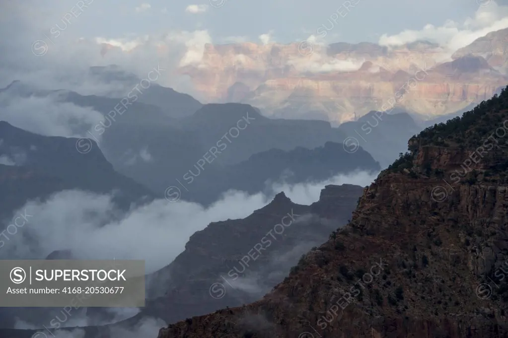 View of the Grand Canyon from Mather Point on the South Rim with clouds rising after a thunderstorm near the Grand Canyon Visitor Center in the Grand Canyon National Park in northern Arizona, USA.