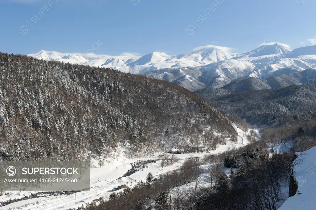 Snowy landscape in the winter with the volcanic Shiretoko mountain range in Abashiri Shiretoko National Park (UNESCO World Heritage Site), Shiretoko Peninsula on Hokkaido Island, Japan.