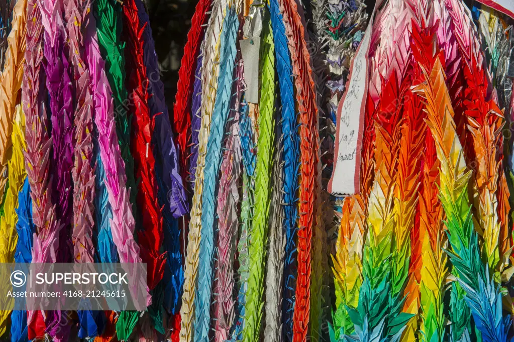 Close up of colorful origami offerings at the Fushimi Inari Taisha shrine, a Shinto shrine in Kyoto, Japan.