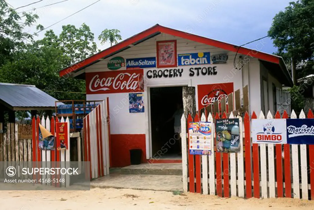 Honduras, roatan island, west end village, street scene, grocery store with coca cola sign