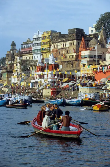 India, Varanasi, Ganges River, View Of Riverfront, Tourists In Boat