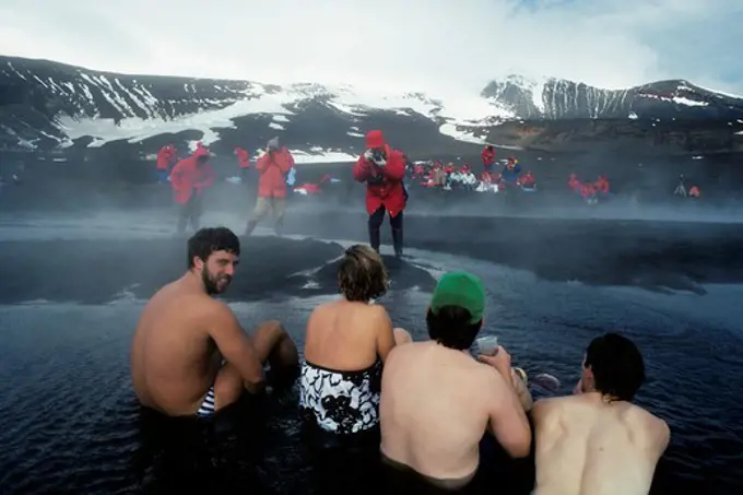 ANTARCTICA, DECEPTION ISL. TOURISTS BATHING IN HOT SPRINGS