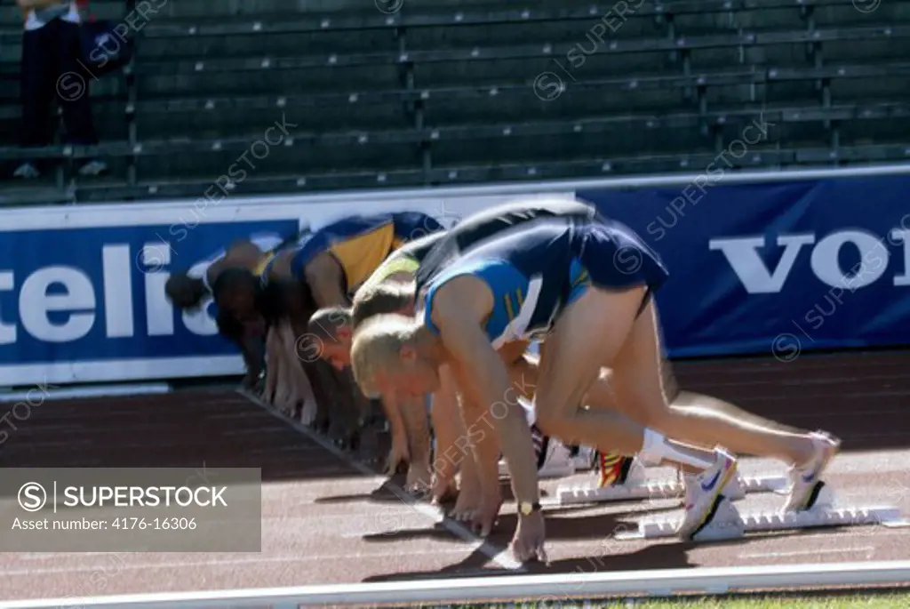 Runners in position on the starting blocks