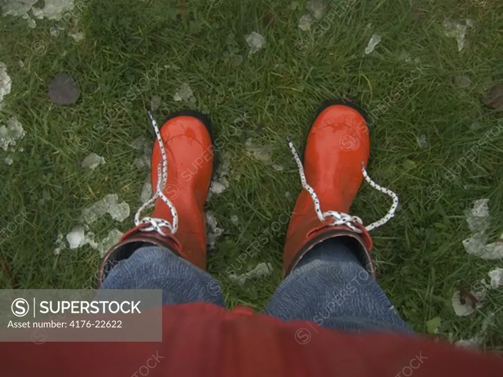 Low section view of a person wearing galoshes