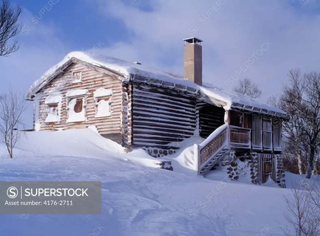 Red cabin in snowy landscape. Harjedalen (Harjedalen) Sweden