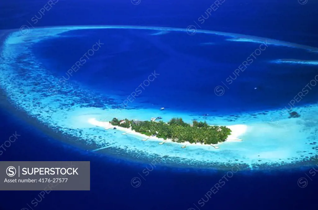 Aerial view of Mayafushi Island with encircling reef in Maldive Islands anchored in Indian Ocean in North East Ari Atoll