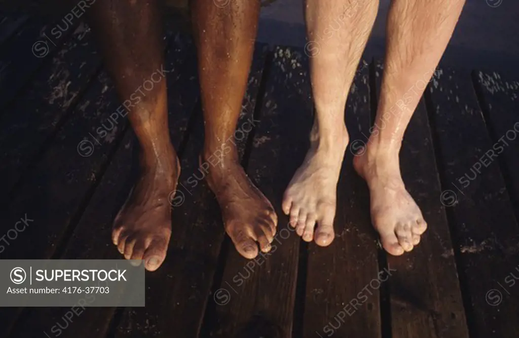 Feet of one caucasian person and one of african ethnicity