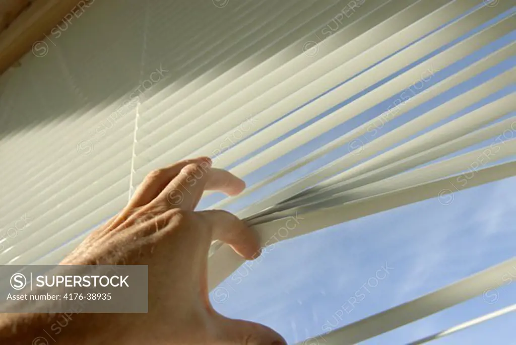 Looking out through blinds.