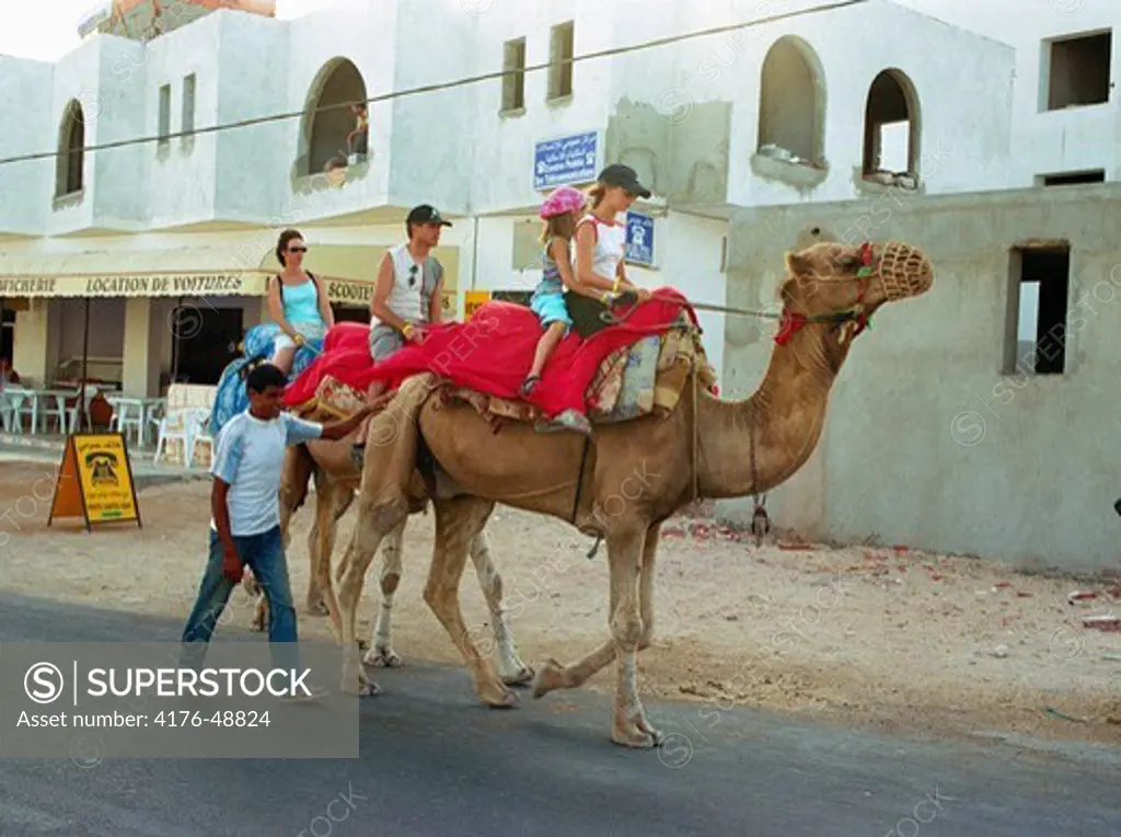 Tourists riding camels. Jerba. Tunisia.