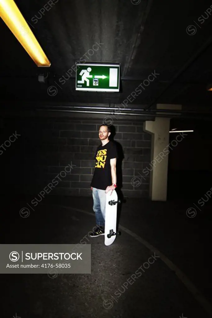 Young man holding a skateboard, Gothenburg (Göteborg), Sweden.