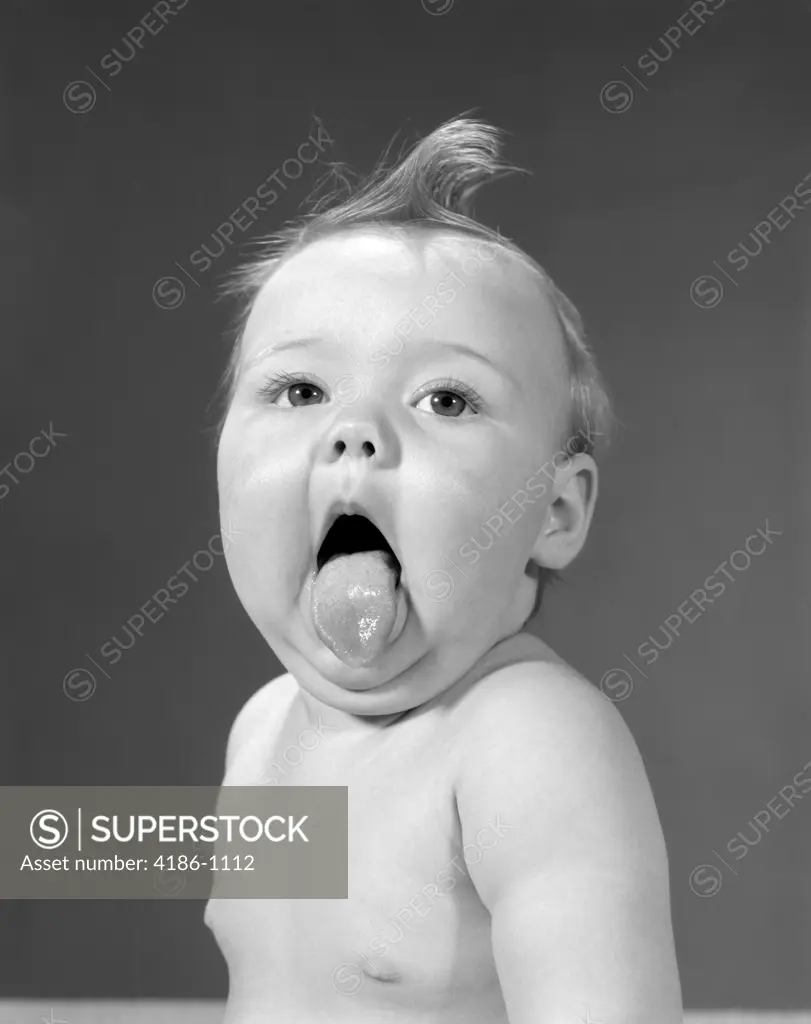 1960S Baby With Curl On Top Of Head & Tongue Sticking Out