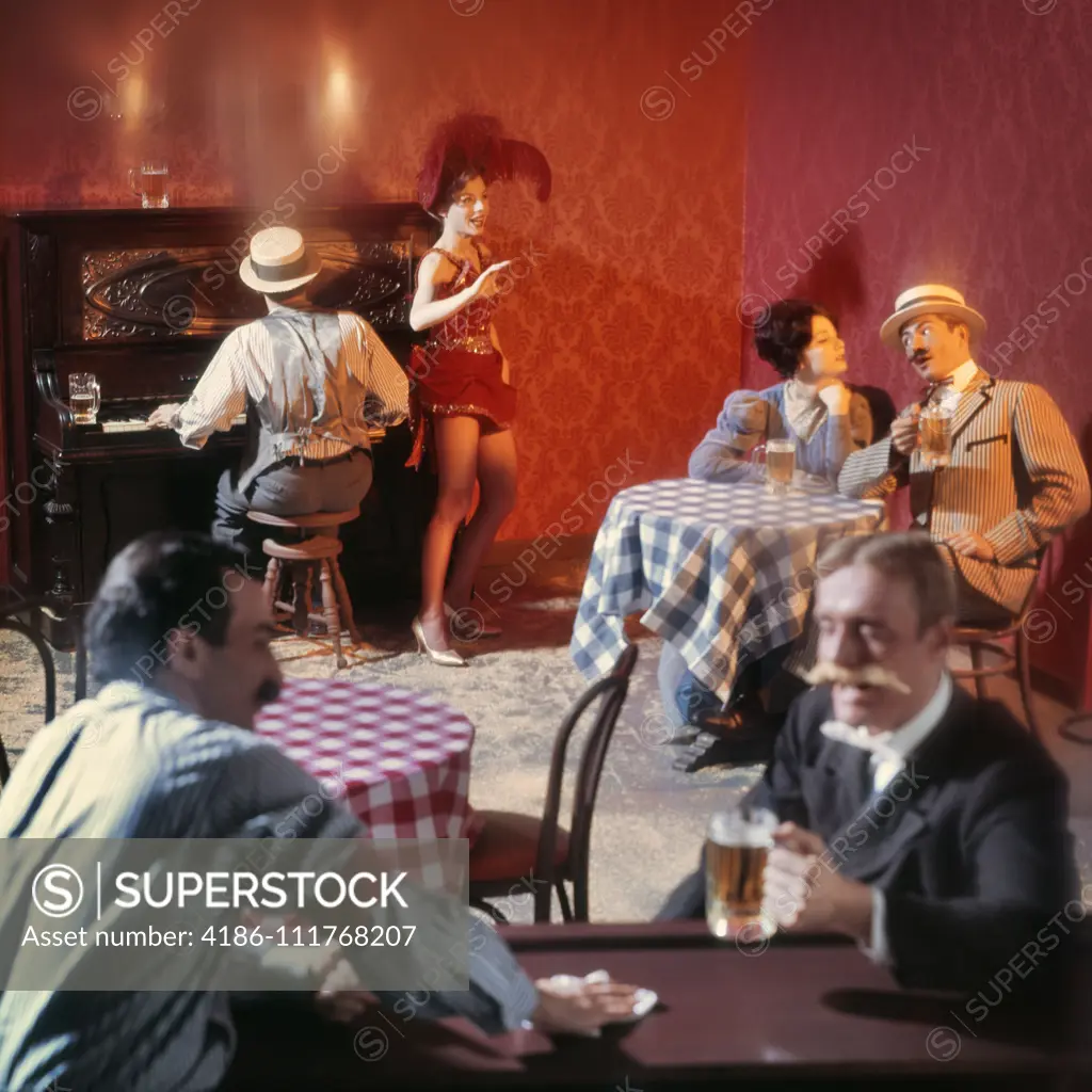 1890s TURN OF THE 20TH CENTURY BAR BEER PARLOR WITH  RAGTIME PIANO PLAYER SALOON SINGER AND PATRONS