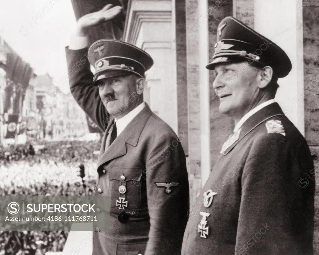 1930s 1940s ADOLF HITLER AND HERMANN GOERING ON BALCONY WAVING TO CROWD CIRCA 1938