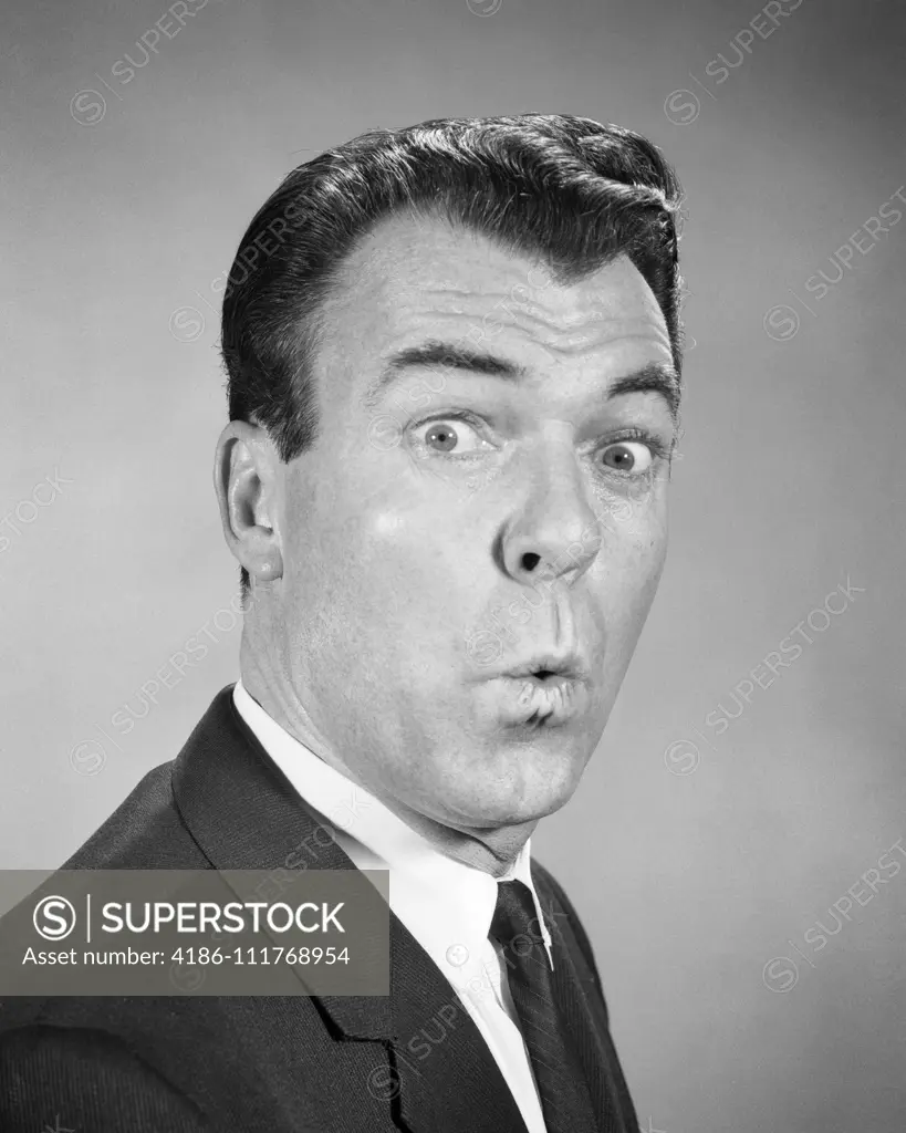 1950s 1960s MAN LOOKING AT CAMERA WITH EYES WIDE LIPS PURSED SURPRISED SHOCKED FACIAL EXPRESSION WHISTLING