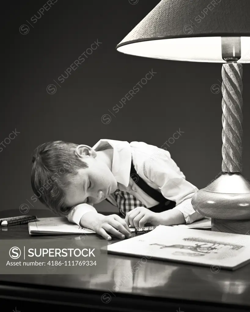 1940s TIRED YOUNG BOY FALLEN ASLEEP OVER HIS COLORING BOOK