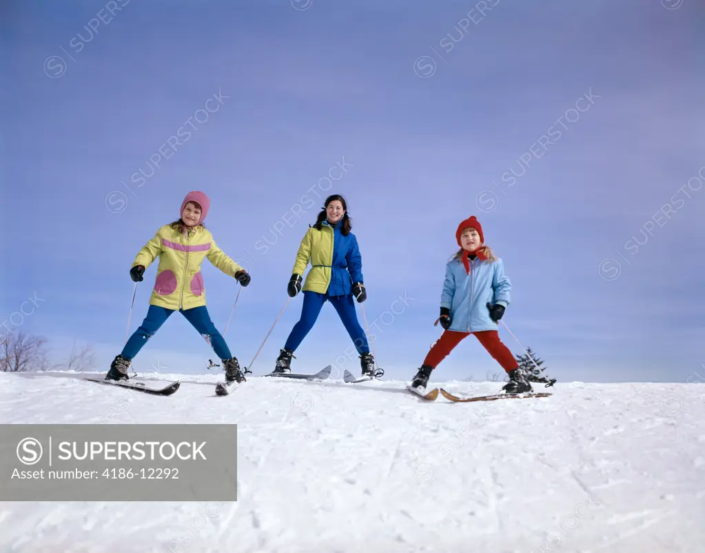 1960S Mother And Two Daughters Skiing Together Winter Outdoor 