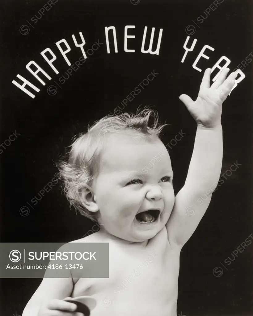 1930S Baby With Mouth Open And Hand Raised With Happy New Year Spelled Out In Arc Over Head