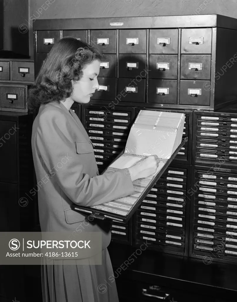 1940S 1950S Woman In Office Standing Near Filing Cabinets