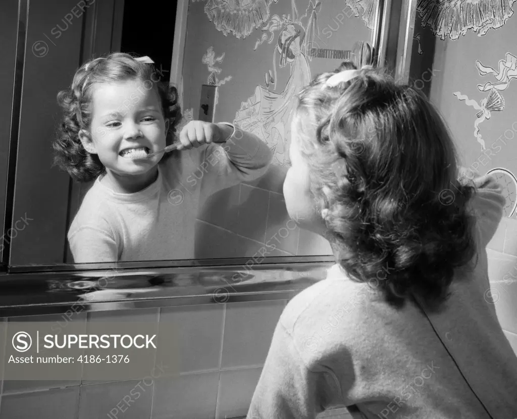 1950S Girl Looking In Bathroom Mirror Brushing Teeth