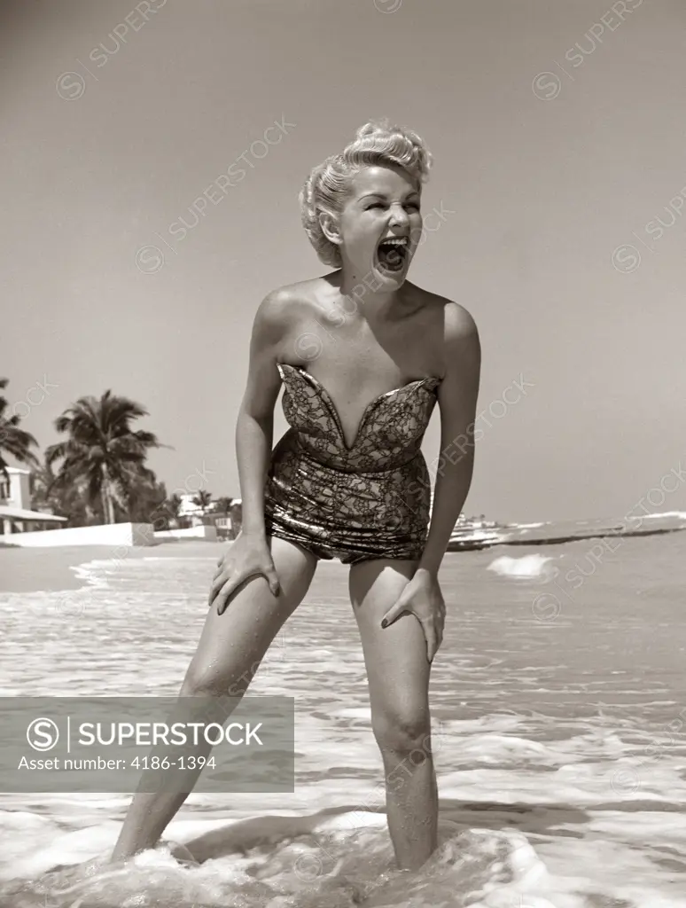 1950S Laughing Blonde Woman In Strapless Low Cut Bathing Suit Swim Wear Wading Up To Ankles In Surf