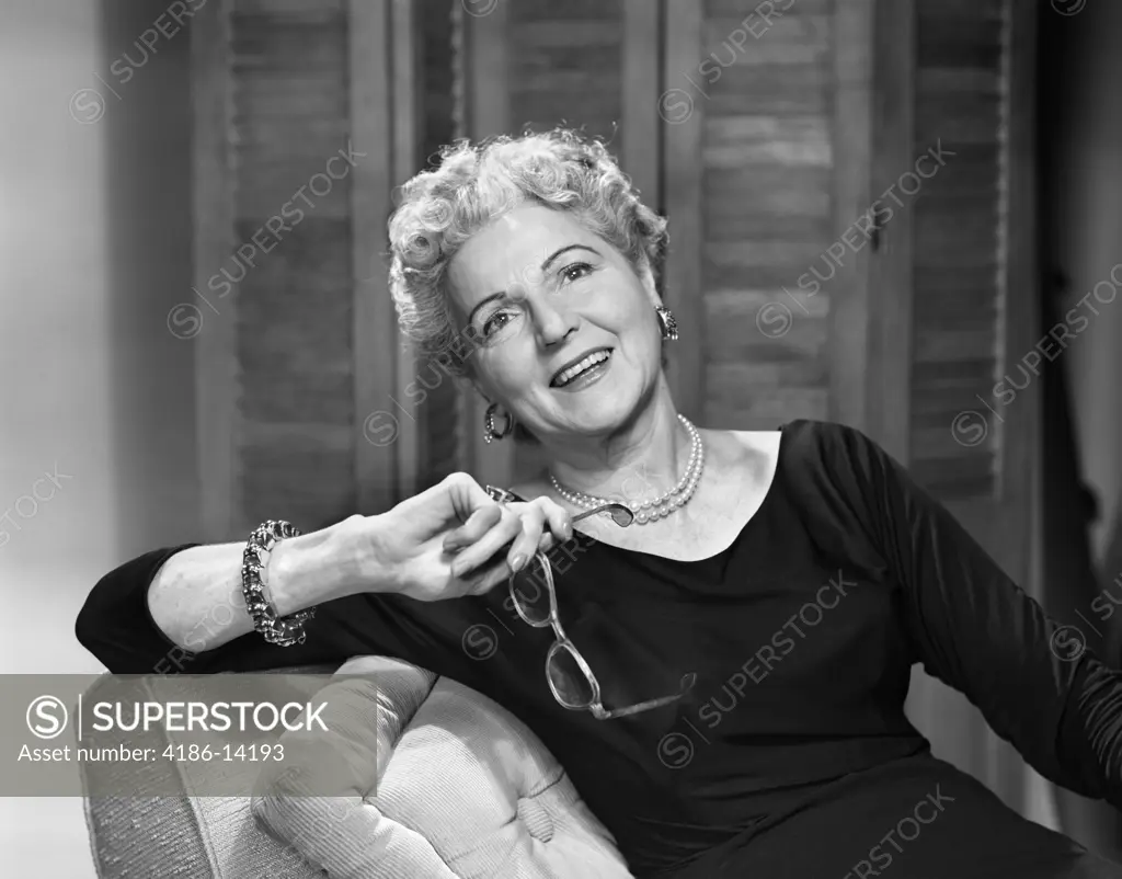 1950S Smiling Fashionable Senior Woman Holding Glasses Wearing Bracelet