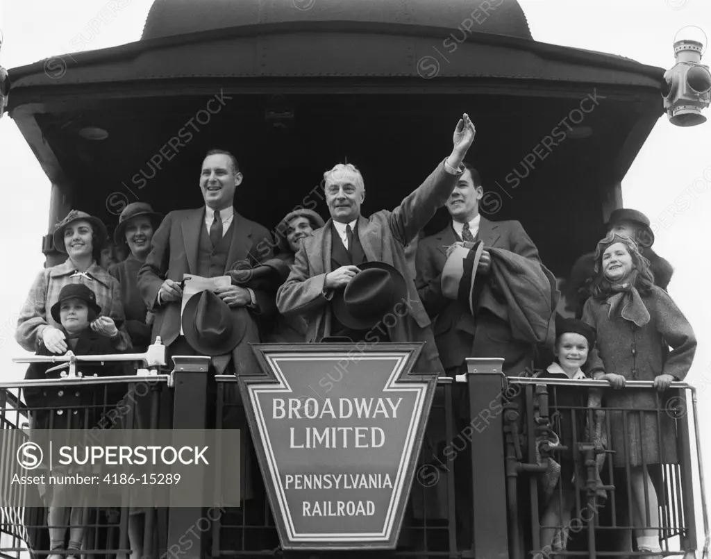 1930S Group Family Men Women Children On Platform Of Caboose Of Train Senior Man Waving