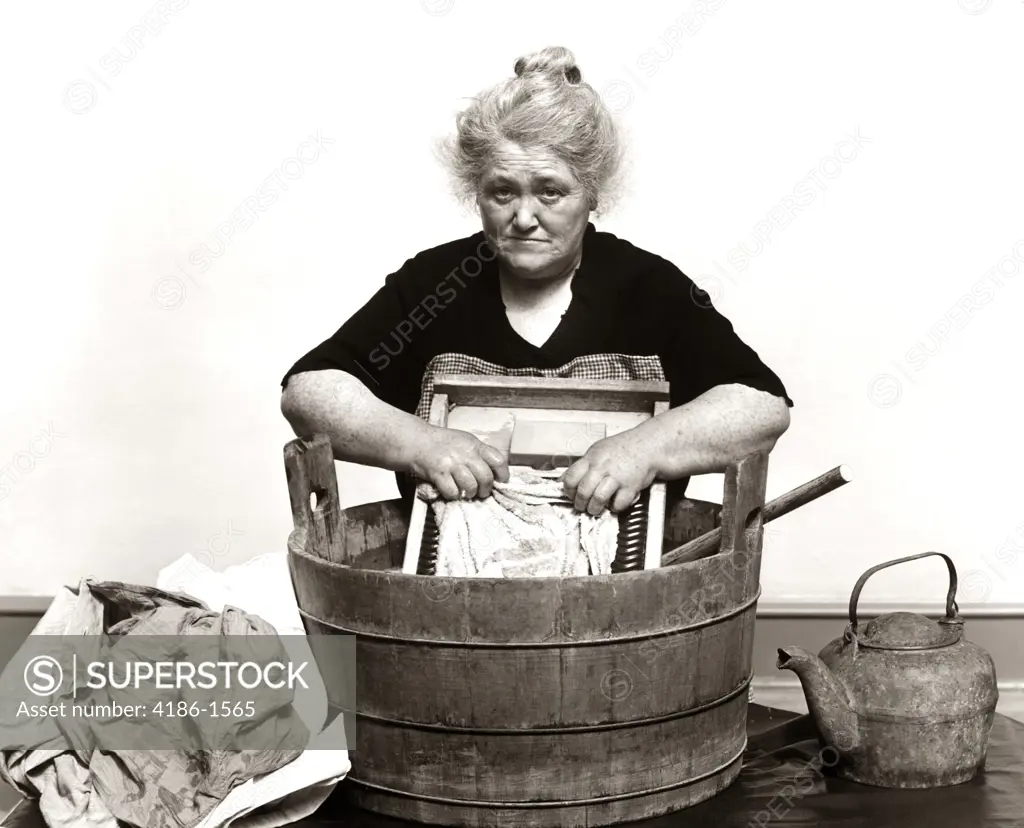 1920S 1930S 1940S Senior Woman Washing Clothes In Old Fashioned Wooden Tub And Washboard