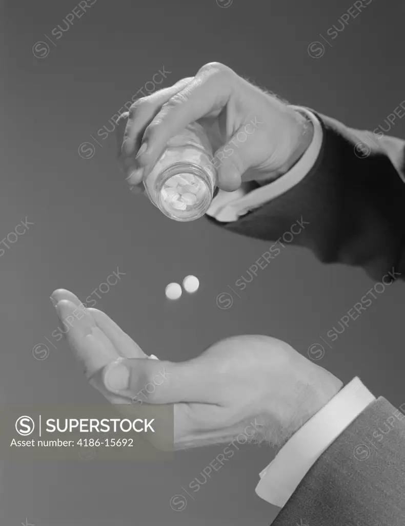 1960S Male Hands Shaking Two Aspirins Pills From Bottle