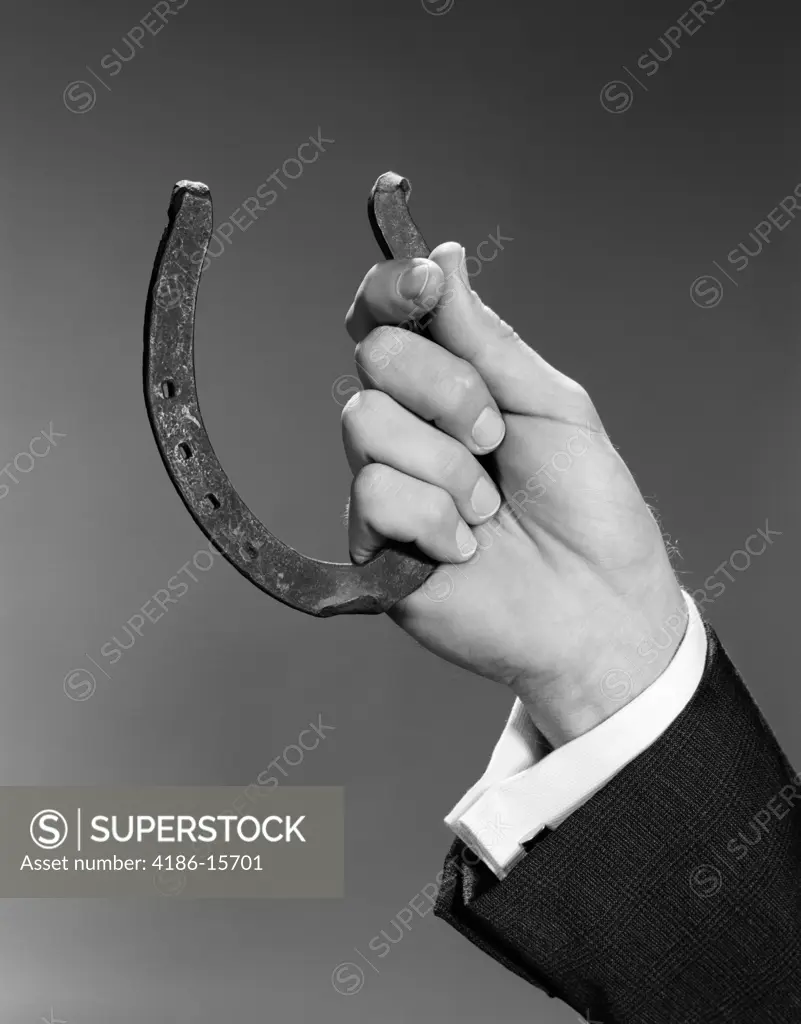 1960S Close Up Man'S Hand Holding Horseshoe Indoor