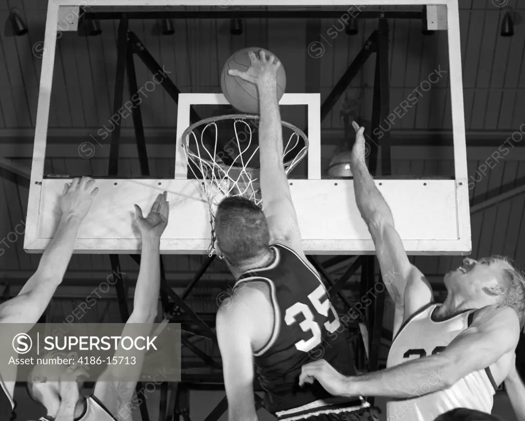 1960S Basketball Player Going Up For Shot With 2 Opposing Players Trying To Block