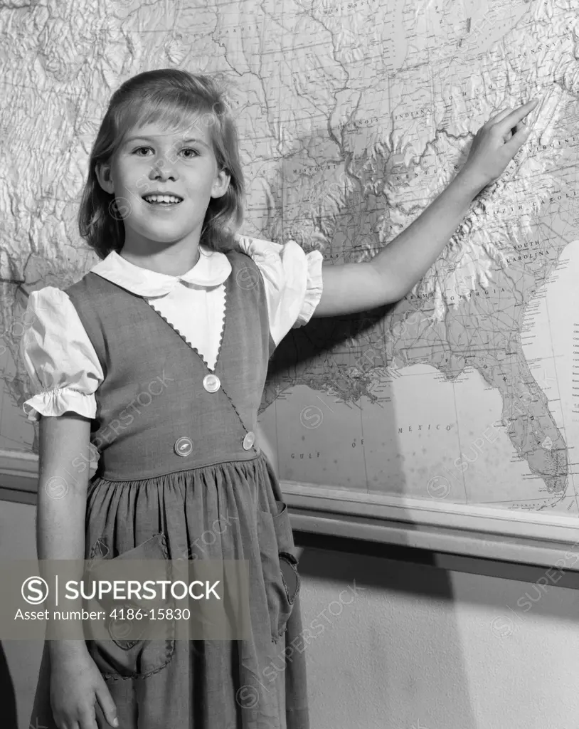 1960S Grade School Girl At Front Of Class Pointing To Map Of United States