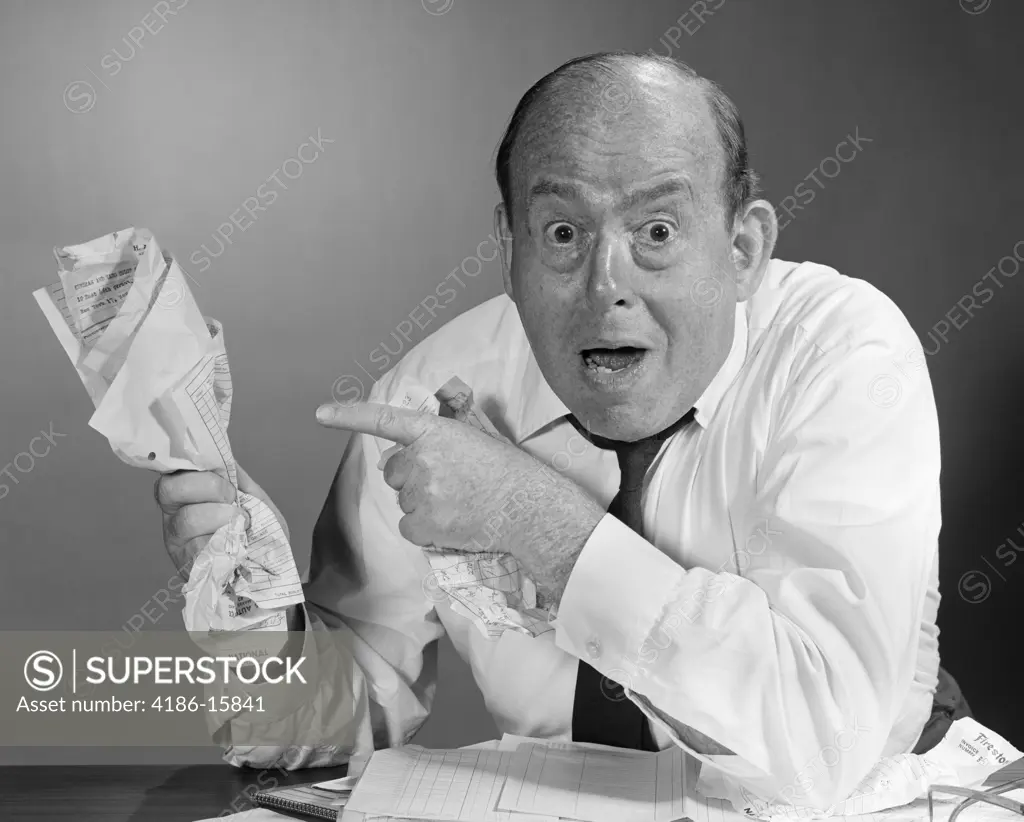 1960S Man Holding Crushed Papers In Hand