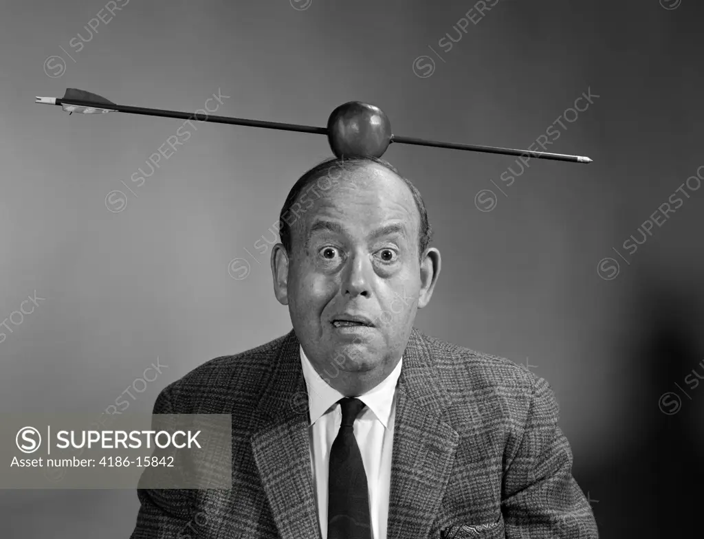 1960S Portrait Man With Arrow Through Apple On Head