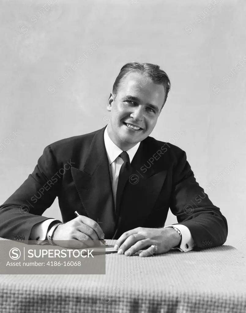 1940S Man In Suit Sitting At Table Writing