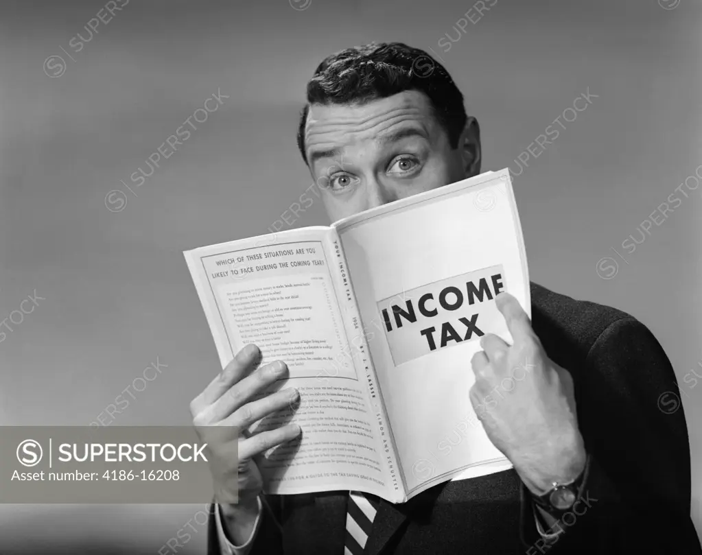 1950S Man In Suit Nose In Income Tax Book