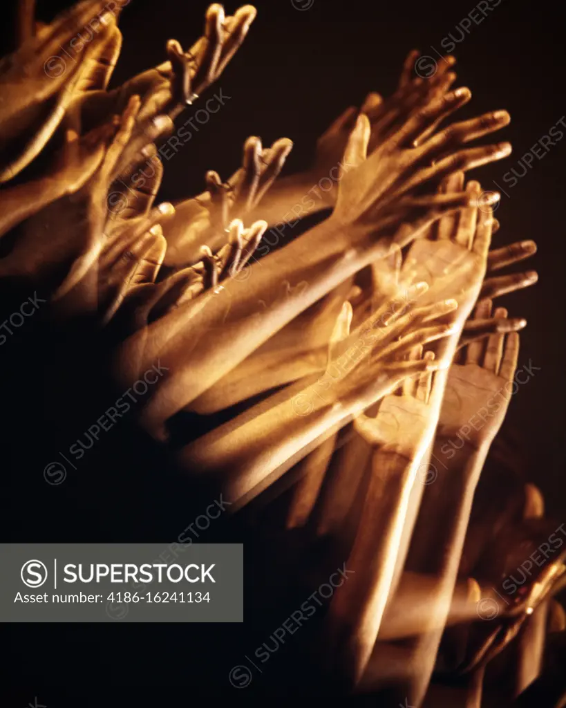 1970s MULTIPLE EXPOSURE OF AFRICAN-AMERICAN CLAPPING HANDS AND ARMS UPLIFTED RAISED IN INVOCATION PRAISE PROTEST OR APPLAUSE