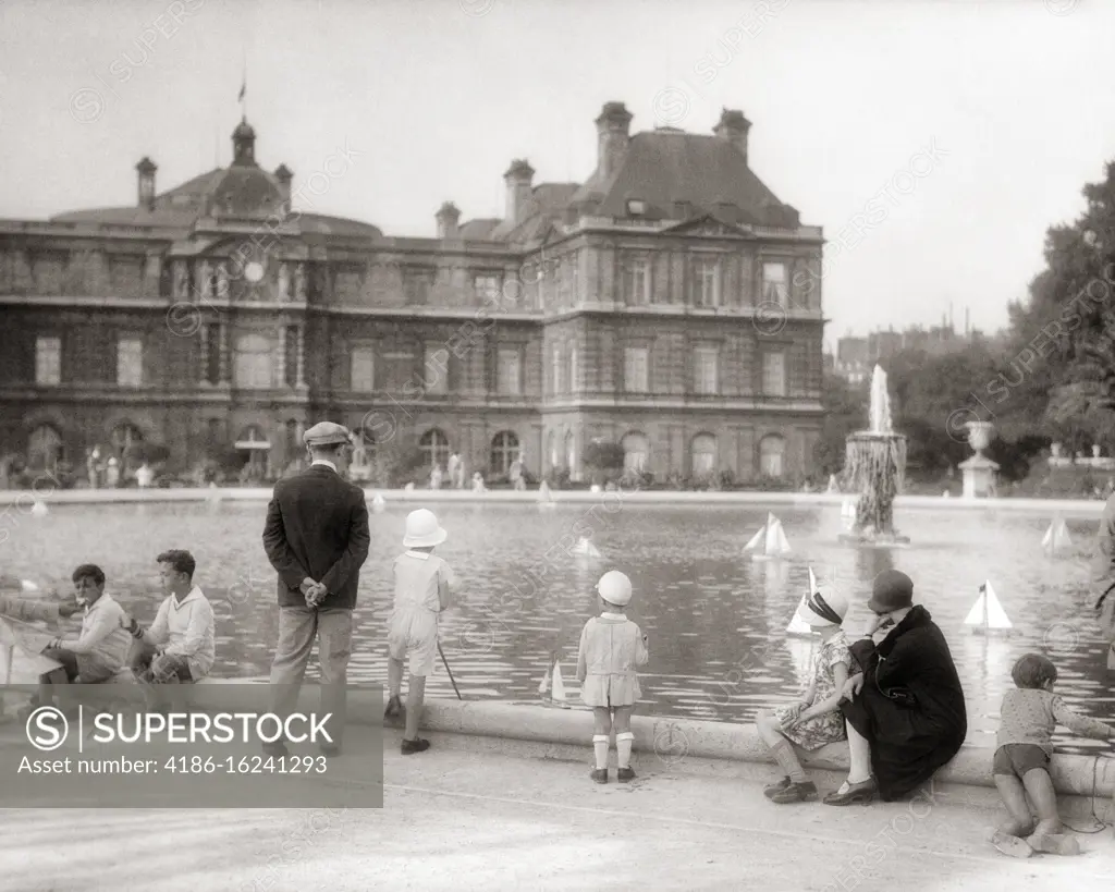 1920s CHILDREN BOYS SAILING TOY BOATS IN POOL LUXEMBOURG GARDENS PARIS FRANCE 