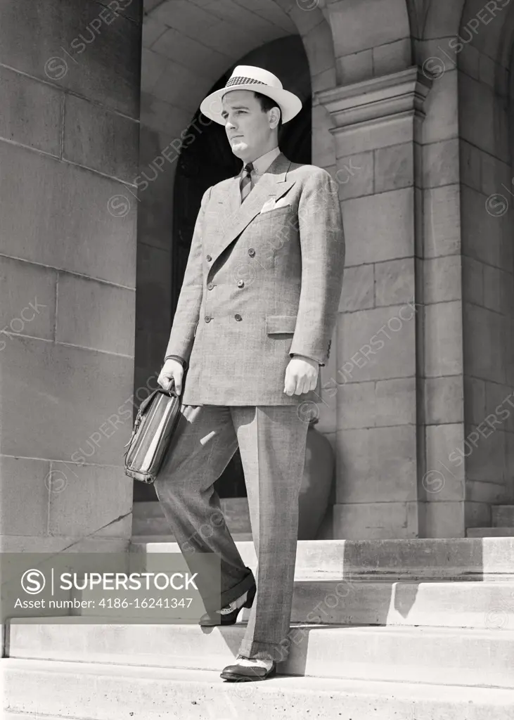 1940s MAN WALKING DOWN STEPS HOLDING BRIEFCASE WEARING GLEN PLAID DOUBLE BREASTED SUIT SPECTATOR WINGTIP SHOES SUMMER WEIGHT HAT