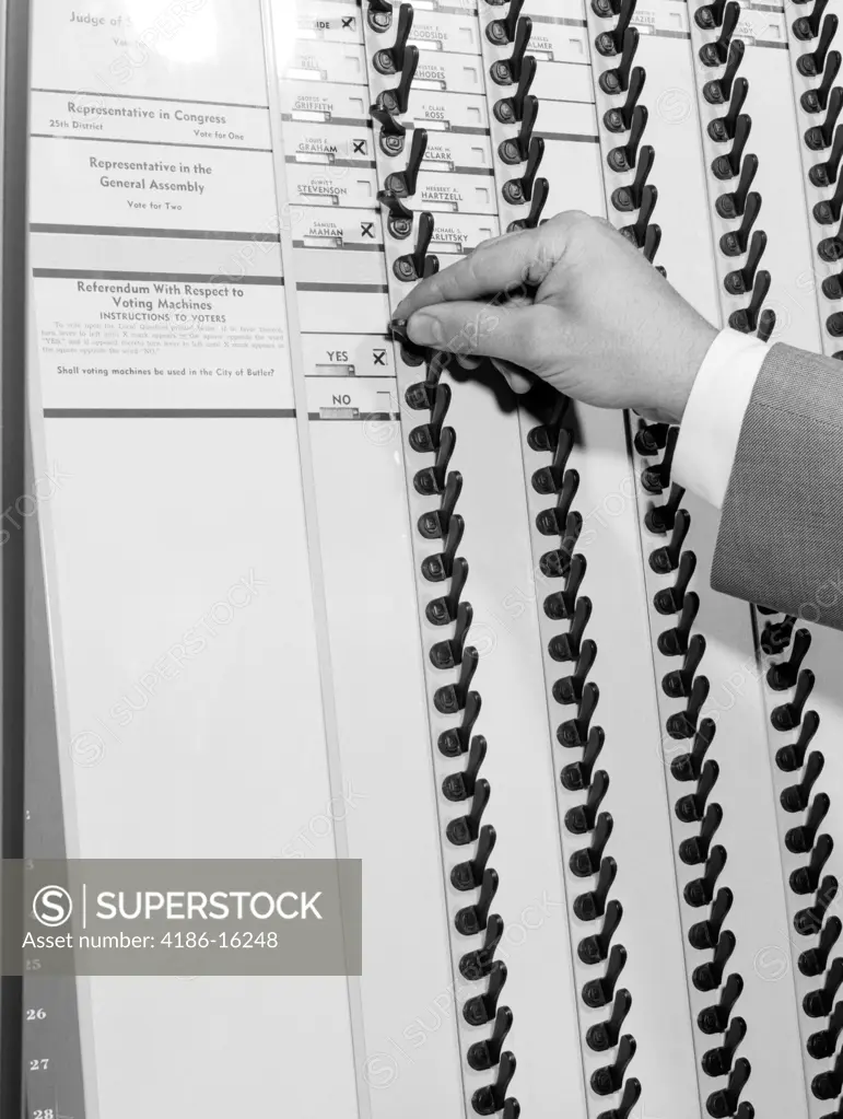 1950S Man'S Hand Pulling Levers In Voting Booth