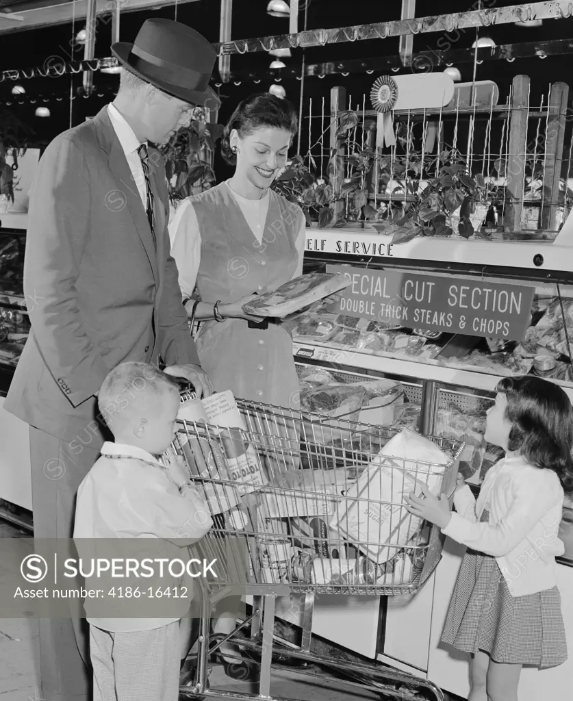 1950S Family Of 4 Inside Supermarket Father Pushing Cart Mother 2 Kids 