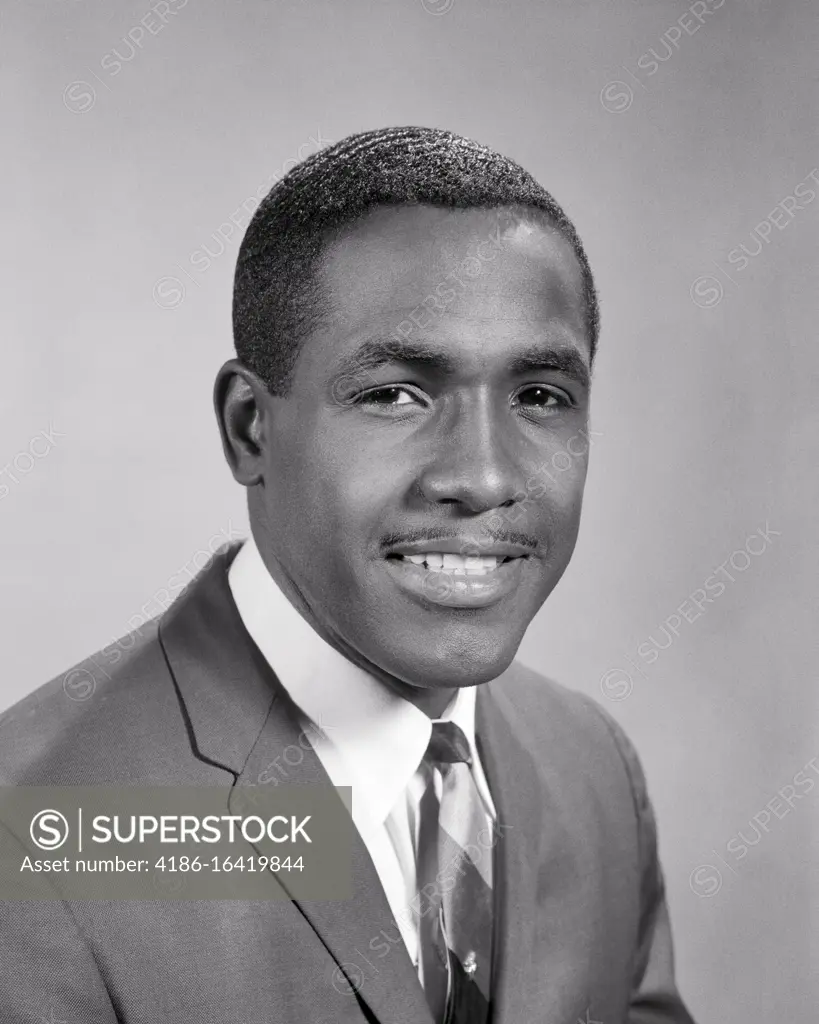 1960s PORTRAIT OF SMILING PROFESSIONAL AFRICAN-AMERICAN MAN WEARING SUIT AND TIE LOOKING AT CAMERA